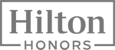 Logo of Hilton Honors, a loyalty program. It features the words "Hilton Honors" in gray text within a rectangular outline.