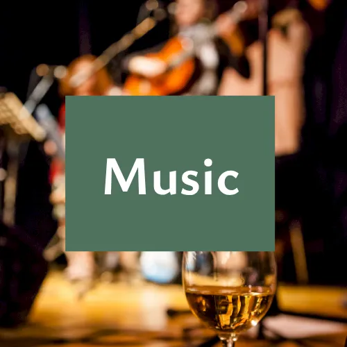 A blurred live band plays in the background with a glass in front and the centered text &ldquo;Music&rdquo; displayed.